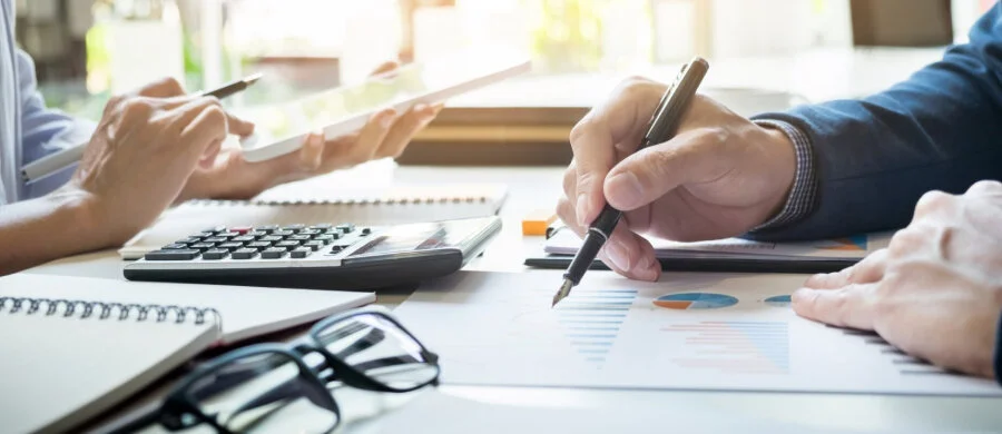 Illustration of an accountant working at a computer with business tracking screens.