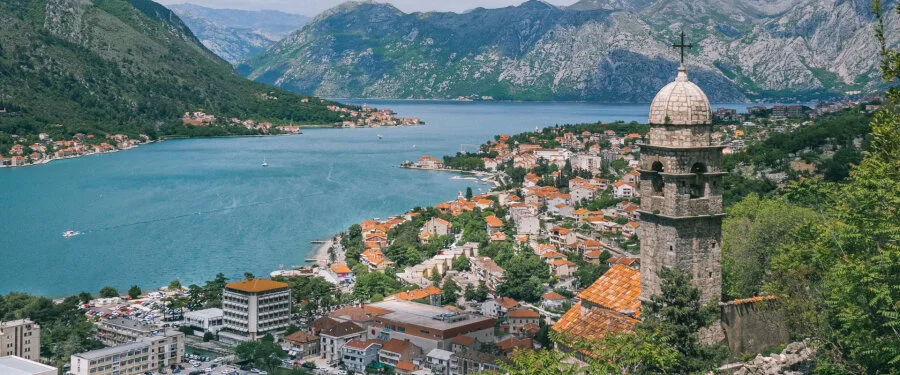 A mountain-lined bay, harbour and historic coastal town in Montenegro.