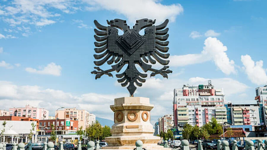The national flag and an office consultation illustration for company formation in Albania.