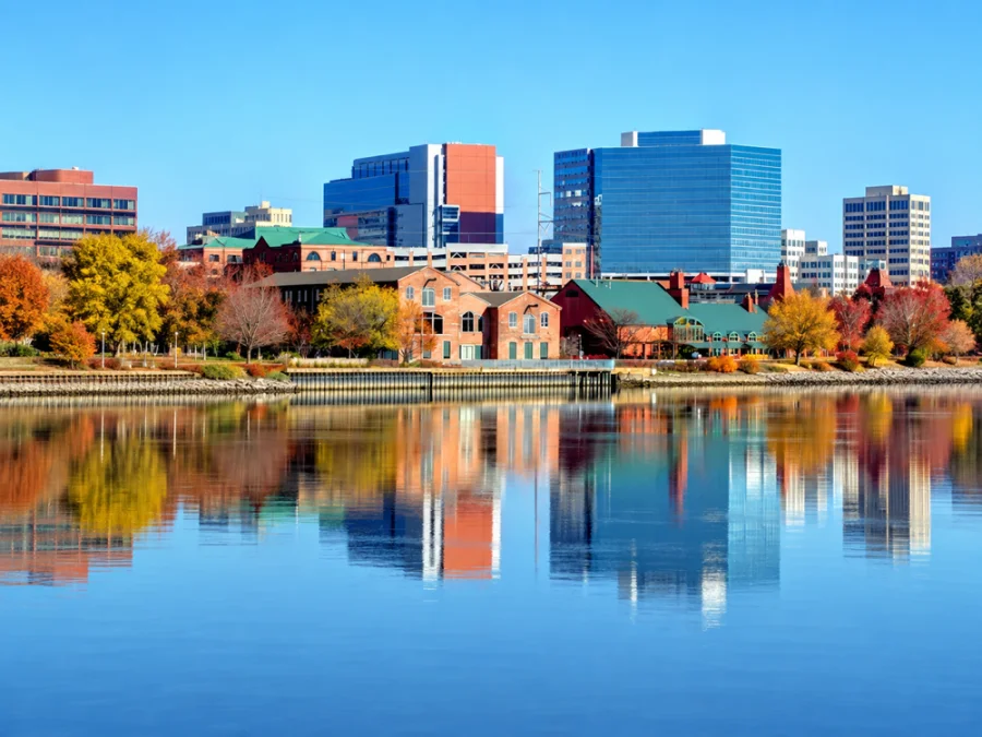 Waterfront office buildings reflected in the water in Delaware.